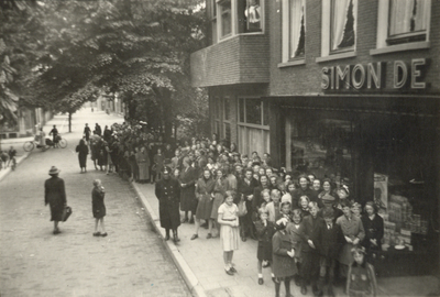 602781 Afbeelding van een rij wachtenden voor de winkel van Simon de Wit (Burg. Reigerstraat 57) te Utrecht waar ...